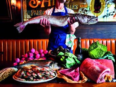Restaurant, Drinks & Travel Trends 2025 - Blue Stoops Pub, man holding a fish above other produce