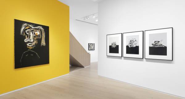 Saura yellow wall with a painting on it next to a white wall with 3 pictures