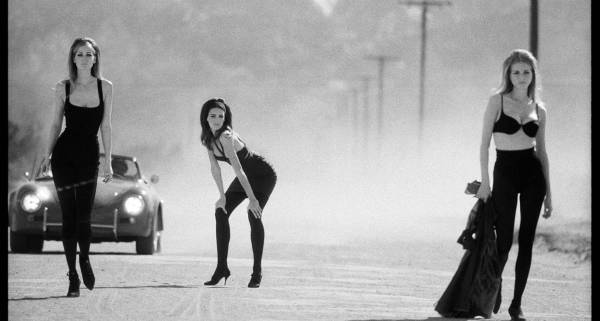 Photo London - three women standing on a road with black dresses and bras