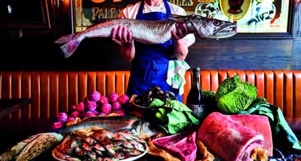 Restaurant, Drinks & Travel Trends 2025 - Blue Stoops Pub, man holding a fish above other produce