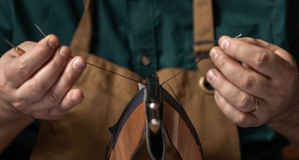 Swaine artisan sewing at their workshop.